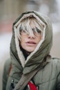 Outdoor portrait of young beautiful happy girl posing on street. Model wearing stylish warm clothes. Magic snowfall. Winter holida Royalty Free Stock Photo