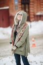 Outdoor portrait of young beautiful happy girl posing on street. Model wearing stylish warm clothes. Magic snowfall. Winter holida Royalty Free Stock Photo