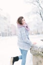 Outdoor portrait of young beautiful happy smiling girl posing on street. Model wearing stylish warm clothes. Magic Royalty Free Stock Photo