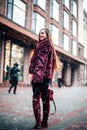 Outdoor portrait of young beautiful happy smiling girl posing on street. Model wearing stylish warm clothes. Magic snowfall. Chris Royalty Free Stock Photo