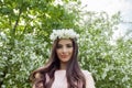 Outdoor portrait of young beautiful happy smiling girl wearing flowers wreath. Spring Royalty Free Stock Photo
