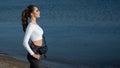 Outdoor portrait of a young beautiful woman walks along the sea coast and basks in the sunset. Text