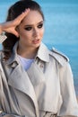 Outdoor portrait of a young beautiful woman who walks along the sea coast and basks in the sunset