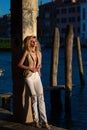 Outdoor portrait of a young blonde woman on city street. Sexy woman walking outdoors. Sensual girl posing on street Royalty Free Stock Photo