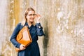 Outdoor portrait of young business woman holding brown leather briefcase Royalty Free Stock Photo