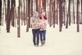 Outdoor portrait of young cheerful teen girl and guy walking in winter time. Hipster couple in love hugging . Valentines day. Royalty Free Stock Photo