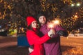 Outdoor portrait of young couple lighting sparkles