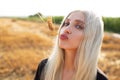 Outdoor portrait of young cute funny girl with wheat spike int he mouth. Royalty Free Stock Photo