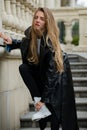 Outdoor portrait of young elegant woman walking in street. Young fashion model, urban style. Attractive woman in vogue Royalty Free Stock Photo