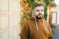 Outdoor portrait of young handsome smiling curly hair style man with beard in spring season - copy space and empty place Royalty Free Stock Photo