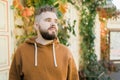 Outdoor portrait of young handsome smiling curly hair style man with beard in spring season - copy space and empty place Royalty Free Stock Photo