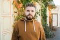 Outdoor portrait of young handsome smiling curly hair style man with beard in spring season Royalty Free Stock Photo