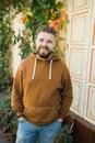 Outdoor portrait of young handsome smiling curly hair style man with beard in spring season Royalty Free Stock Photo