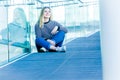 outdoor portrait of young happy smiling teen girl on a glass bridge on natural background