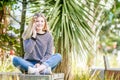 outdoor portrait of young happy smiling teen girl using cell phone, natural outdoor background Royalty Free Stock Photo