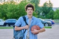 Outdoor portrait of young male college student with backpack, basketball ball Royalty Free Stock Photo