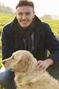 Outdoor Portrait Of Young Man With Golden Retriever Royalty Free Stock Photo