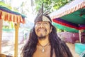 Portrait of young native american man with long black hair and Indian headdress Royalty Free Stock Photo