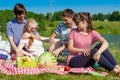 Outdoor portrait of young people having a picnic, eat watermelon Royalty Free Stock Photo
