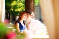 Outdoor portrait of young sensual couple in summer cafe. Love an Royalty Free Stock Photo