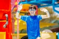 Outdoor portrait of young smiling child having fun in aquapark. Enjoying day trip to an aqua amusement park Royalty Free Stock Photo