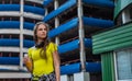 Portrait of young teenager brunette girl with long hair. Teen Girl Drinking a Bottle of fresh orange Juice on parking Background o Royalty Free Stock Photo