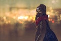 Outdoor portrait of young woman with gas mask in winter with bokeh light on background