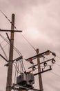 Outdoor power transformer against the background of clouded sky.