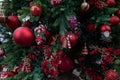 Outdoor pretty decorated Christmas tree with bright red balls and toys