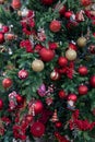 Outdoor pretty decorated Christmas tree with bright red balls and toys