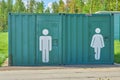 Outdoor public toilet booths with male and female symbols Royalty Free Stock Photo