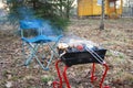 Outdoor recreation. Folding chair and barbecue. Food cooked over a fire.