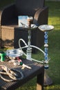 Outdoor recreation with a hookah and a wicker chair. Royalty Free Stock Photo