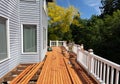 Outdoor red wooden cedar deck being remodeled with new floor boards freshly installed Royalty Free Stock Photo