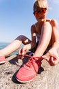 Young girl tying shoelace. Royalty Free Stock Photo