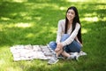 Outdoor Relax. Portrait Of Young Asian Girl Sitting On Plaid In Park Royalty Free Stock Photo