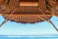 Outdoor restaurant at the beach. Cafe on the beach, ocean and sky. View to beach from bar in Bali, Indonesia. Relaxing on remote Royalty Free Stock Photo