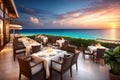 Outdoor restaurant at the beach. Table setting at tropical beach restaurant. beautiful sunset sky, sea view. Luxury Royalty Free Stock Photo