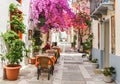 Outdoor restaurant in the narrow streets of Nafplion town with beautiful Bougainvillea flowers