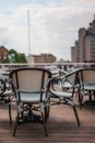 Outdoor restaurant tables and chairs in St Katherine\'s Dock in London, UK Royalty Free Stock Photo