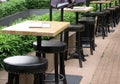 Outdoor restaurant tables and leather high stools Royalty Free Stock Photo