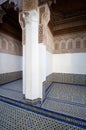 An outdoor room with a mosaic tiled floor and wood carvings in a palace in Morocco