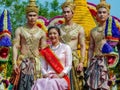 Beauty contestant and three guards in traditional costumes