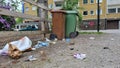 Outdoor scene featuring two wheeled garbage cans