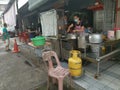 Outdoor scene of a lady preparing take back noodle as the customers waiting at Kg Koh favorite Noodle shop,