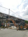 Outdoor scene of workers digging and piling concrete pole preparation for 5G cable connection