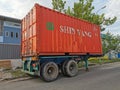 Outdoor scenery during day time with 20 feet container truck park by the road side.