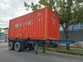 Outdoor scenery during day time with 20 feet container truck park by the road side.