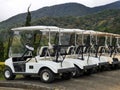 Outdoor scenery during day time with a row of golf carts. Royalty Free Stock Photo
