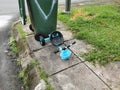 Outdoor scenery in the morning at apartment garbage collection area with broken children tricycle and dustbin